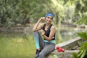 Pretty Lady Listening To Music With Earphones After Exercising photo