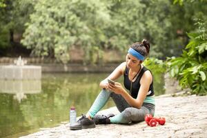 Beautiful Lady Chatting On Mobile Phone After Workout photo