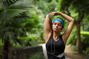 Attractive Mature Woman Doing Warmup Exercise Stretching Her Arms Before Workout photo