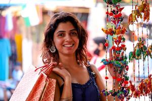 Smiling Lady Posing With Multicolour Rajasthani Hanging Decoration photo