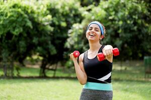 Lady Working Out With Dumbbells In Front Of Camera photo