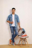 A Good-Looking Man In A Casual Denim Outfit Is Posing While Standing photo