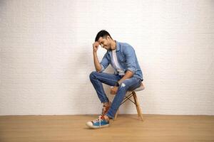 Shy Guy Is Blushing While Sitting On Chair photo