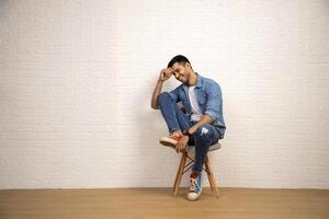 Stylish Man Is Posing While Sitting On Chair photo