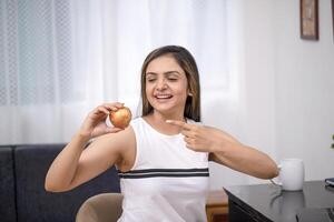 Modern Female In White Outfit Pointing Her Finger At Apple photo