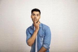 Surprised Man With Two Fingers On Lips photo