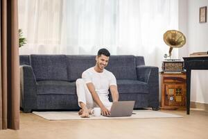 Professional Businessman Looking At Laptop And Smiling photo