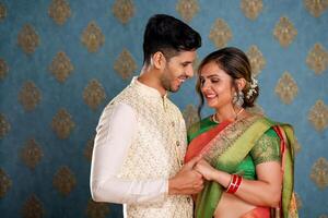 Happy Married Couple In Indian Outfit Holding Hands photo