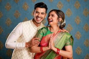 Grinning Beautiful Indian Pair Greeting Namaste While Posing For Camera photo