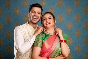 Happy Cute Couple In Indian Traditional Outfit Posing For Camera photo