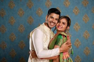 Beautiful Indian Couple Hugging Each Other While Posing For Camera photo