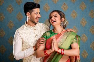 A Young Couple Enjoying Themselves While Holding Shopping Bags And Sitting On A Chair In Front Of The Camera photo