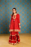 Picture Of A Beautiful Woman In A Red Indian Suit photo