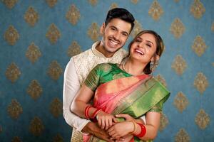 Image Of A Couple Smiling In Front Of The Camera Wearing Traditional Outfits photo