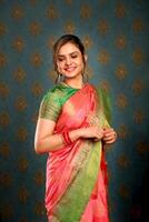 Smiling Female In Saree While Standing In Front Of The Camera photo