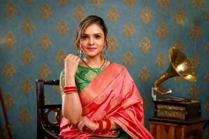 Asian Model Image Seated On A Chair In Traditional Indian Attire photo