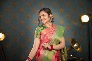 A Shy Lady In Traditional Indian Saree During Diwali Festival Posing In Front Of The Camera photo