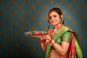 Indian Housewife In Saree Holding Oil Lamp Plate During Diwali Festival photo