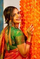 Picture Of An Adorable Couple Wearing Traditional Indian Attire Holding A Plate Of Ladoos In Their Hands And Smile photo