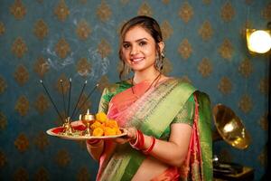 Asian Cute Model In Saree Holding Pooja Plate photo
