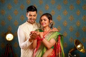 Gorgeous Model Couples Holding Diya While Celebrating Diwali Festival photo