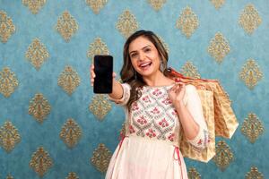 A Lovely Lady Showing Her Smartphone Screen To The Camera photo