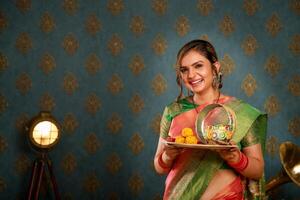 Sweet Wife In Saree Holding Puja Plate In Hand During Karwa Chauth Festival photo