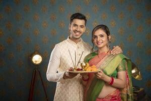 A Young Couple Enjoying Themselves While Holding Shopping Bags And Sitting On A Chair In Front Of The Camera photo