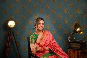 Smiling Beautiful Couple In Traditional Indian Attire Holding Plate Of Ladoo photo
