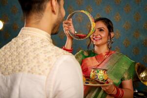 Handsome Indian Man Smiling While Turning Back While Holding Book In Hand photo