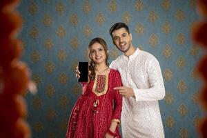 Handsome Indian Man Smiling While Turning Back While Holding Book In Hand photo