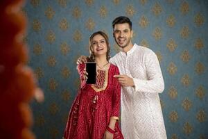 Handsome Indian Man Smiling While Turning Back While Holding Book In Hand photo