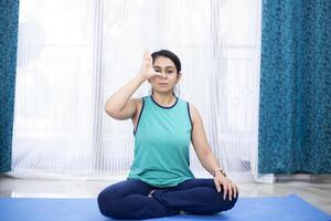 Yoga Babe Practicing Alternate Nostril Breathing Exercise photo