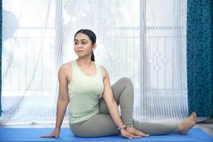 Sexy Woman Doing Yoga Spinal Twist Pose photo