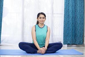 Yoga Lover Practicing Bound Angle Pose At Home photo