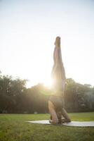 Slim Female Doing Sirsasana photo