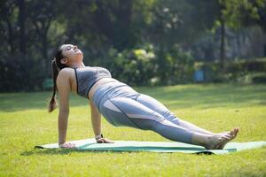 Indian Young Lady Doing Upward Plank Pose photo