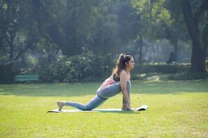 Fitness Freak Woman Doing Surya Namaskar photo