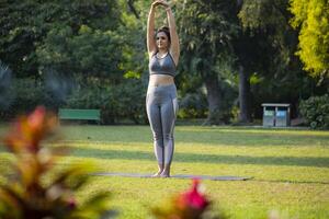 Happy Female Doing Palm Tree Pose in the Outdoor photo