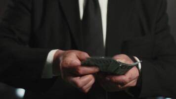 Close-up of hands of a businessman in formal business suit counting a stack of banknotes. Concept of reasonable and careful financial management video