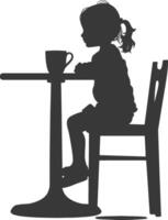 silueta pequeño niña sentado a un mesa en el café negro color solamente vector