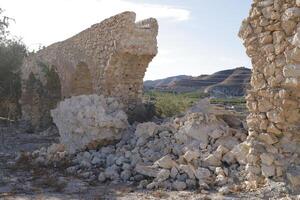 roman aqueduct in antas, spain photo