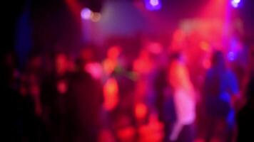 blurred silhouettes of people dancing on the dance floor in a nightclub video