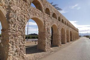 roman aqueduct in antas, spain photo