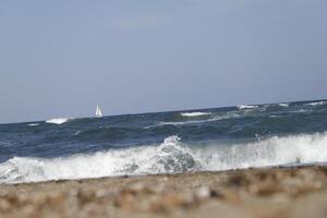 no straight horizon, it feels like you are swaying on the wavessailboat at sea, waves on the coast photo