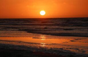 sunset at vlieland, dutch island in the sea photo