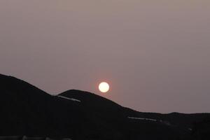 sunset in the mountains, sahara sand in the sky, spain photo