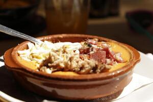 spanish food, delicious, salmorejo, cold tomato soup with raw ham and egg photo