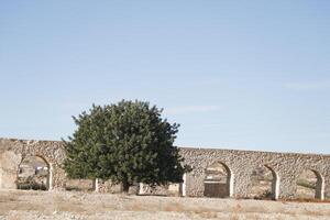 roman aqueduct in antas, spain photo