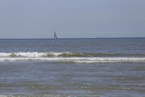sailboat on the north sea, seen from the shore photo